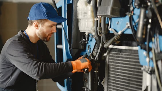 man performing maintenance on truck fitted with tracklogix gps tracker